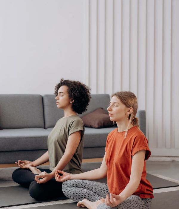Calm woman in a soft yoga pose, embodying peace and balance.